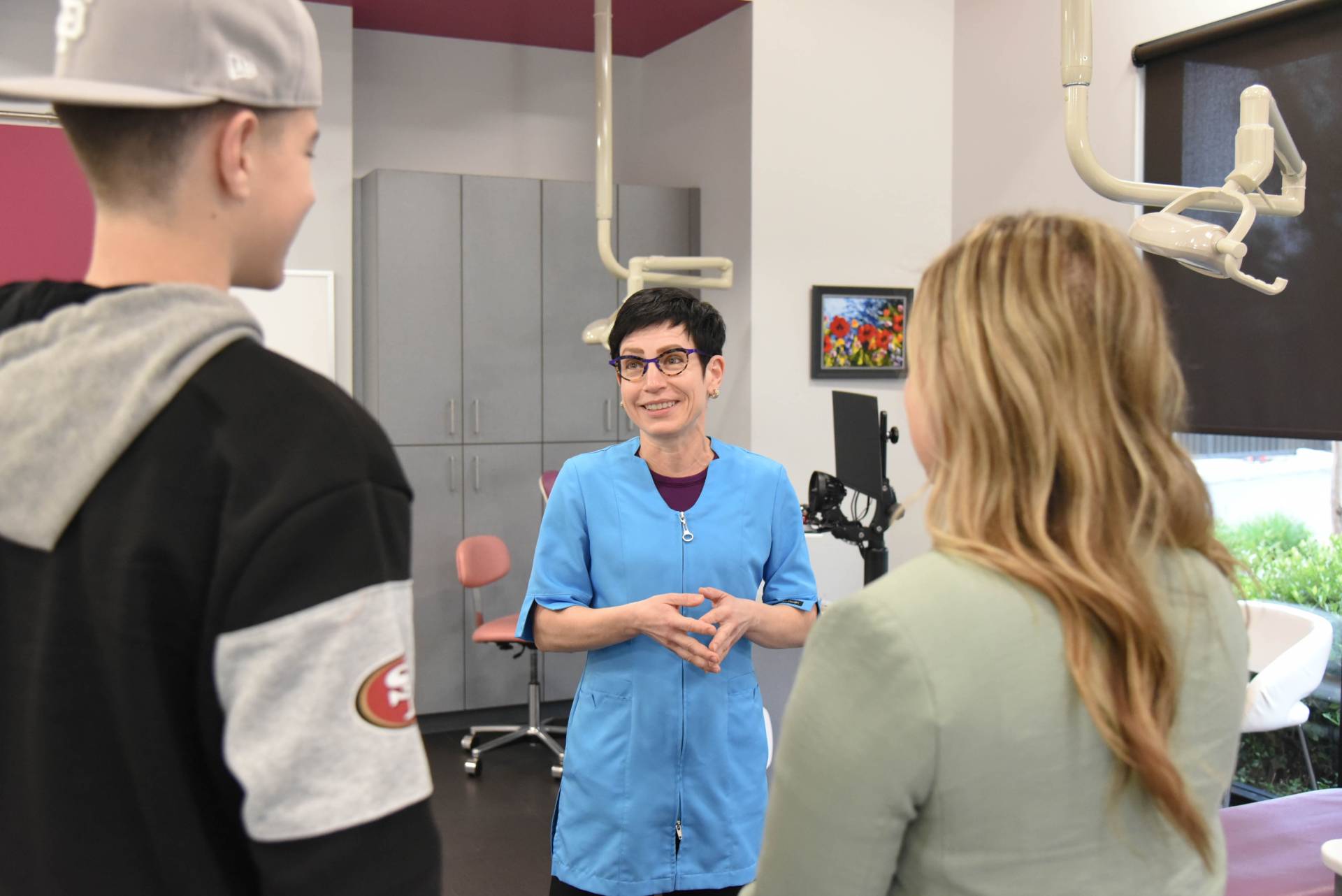 Dr. Marina Milstein talking with a patient about braces vs Invisalign treatment options